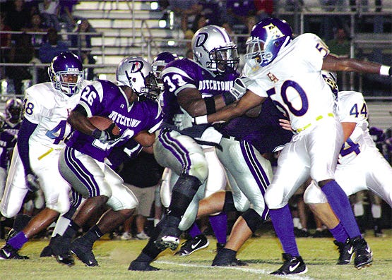 Dutchtown’s Effrem Reed follows the blocking of Kelvin York as East Ascension’s Ryan Moll and Andrew Parms pursues in the Griffins’ victory last week. Reed,?York and the Griffins host East St. John Friday night.