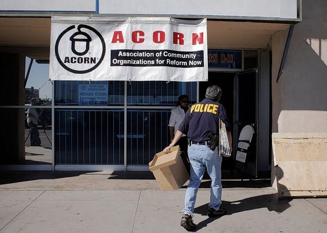 AN INVESTIGATOR enters the ACORN office in Las Vegas this week. A Nevada secretary of state's office spokesman said investigators are looking for evidence of voter fraud at the office.