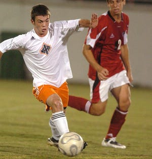 New Hanover’s Parker Antis pushes the ball against Jacksonville’s defense Thursday night in a Mideastern Conference showdown. The Wildcats’ victory gives them the inside track to the league championship with two games to play.