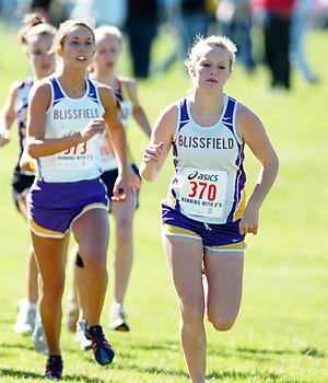 Blissfield High’s Brittany Holdridge, right, helps the Royals to a second-place finish in the LCAA cross country championships.