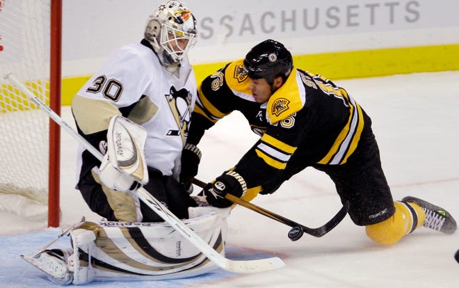 Boston Bruins defenseman David Krejci, of the Czech Republic, slams into Pittsburgh Penguins goalie Dany Sabourin after taking a breakaway shot in the second period of an NHL hockey game in Boston, Monday, Oct. 20, 2008. (AP Photo/Charles Krupa)