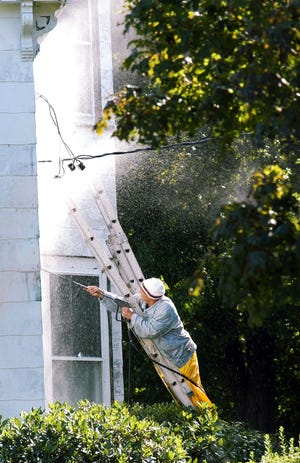 A Market Street home gets a power wash in Rockland.