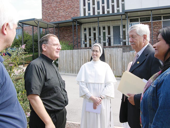 The Rev. Bill Mackenzie, second from left, talks with Oak Ridge City Manager Jim O'Connor, from left, St. Mary's School Principal Sister Anne Catherine, Mayor Tom Beehan, and Music Ministry Coordinator Francine Britto, during a tour of the St. Mary's Church and School complex.