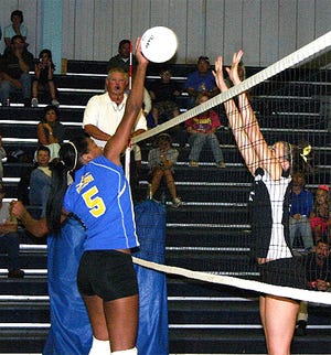 East Ascension’s Whitney Delmore goes up for a dink attempt on St. Amant’s Victoria Ojea in second game of the Lady Gators’ 3-1 victory Wednesday night.