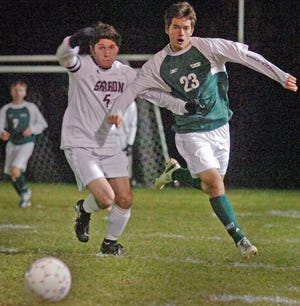 Canton's Igor Perun (23) and Sharon's Wes Gemba (5) race for the ball.
