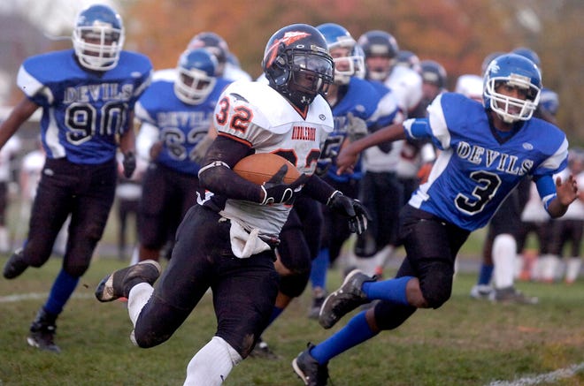 Middleboro running back Dom Bailey, center, carries the ball as he's being chased by Randolph's Jason Dillon-Johnson (90) and Binyam Adhanom (3).