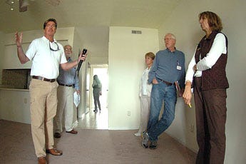 Spencer Jarnagin talks to prospective buyers in a condo at Carolina Beach during the Century 21 Brock and Associates Foreclosure Tour on Saturday.
The home was one of the 14 that were looked at on the tour.