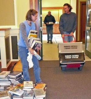 Library staffers and Gardiner citizens move books in preparation for the grand opening of the new Gardiner Library at 133 Farmer's Turnpike.