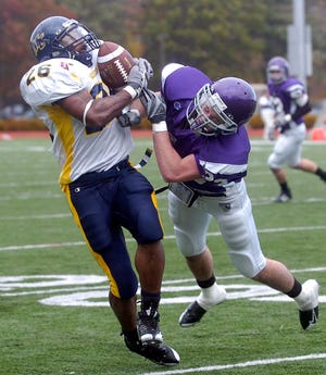 Stonehill College defender Joshua Bendaw unloads on Merrimack College running back Richard Johnson of Brockton as Johnson comes out of the backfield to make the catch Saturday.


WITH STORY BY JIM FENTON