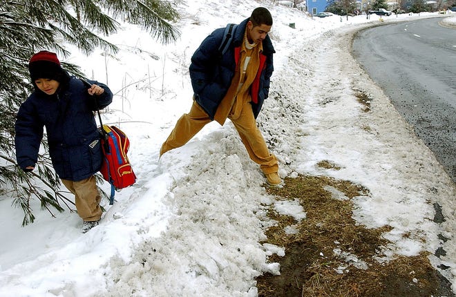 Brothers Joe, right, and Paul Vassell make their way up an uncleared Goddard Drive in this file photo.