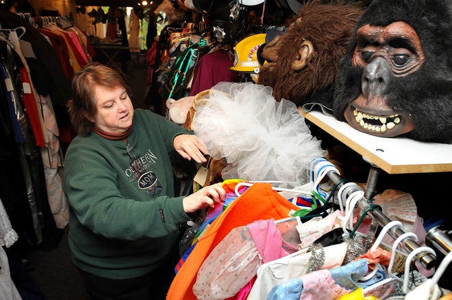 Linda Adams-Foat, owner of Camelot Costumes in Freeport, arranges costumes at the store for customers searching for their Halloween look Monday, October 27, 2008.