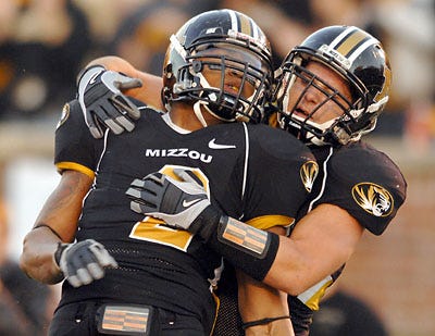 Missouri's Brian Coulter is congratulated by Luke Lambert after Coulter tackled Colorado punter Tom Suazo for a 15-yard loss Saturday. In the shutout of the Buffs, Coulter showed the pass-rushing skills that created much hype this summer.