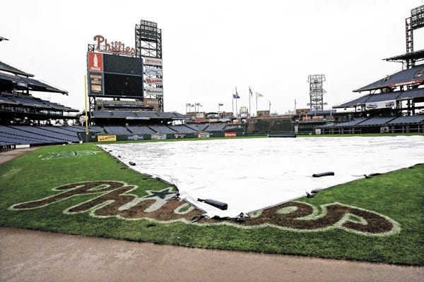 A tarp covers the infield in Citizens Bank Park to protect it from rain in Philadelphia, Tuesday, Oct. 28, 2008. Game 5 of the baseball World Series between the Tampa Bay Rays and Philadelphia Phillies, which was suspended on Monday evening due to heavy rain, was postponed until Wednesday, Oct. 29.