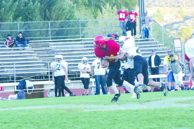 Tim Maphet fights for yards after a nice catch vs. Corning in NAL freshman football, won by the Cards 54-13 at Miner Stadium.