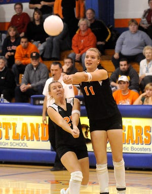 Stefanie Weiss / The Journal-Standard  
Milledgeville's Taylor Kent bumps the ball as Andrea Herin watches during the game against Aquin at Eastland High School's regional volleyball tournament Wednesday.