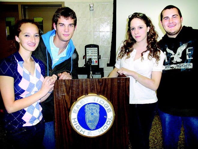 During a reception to welcome students from Rennes, France, who are visiting Eastridge High School through Nov. 1, Eastridge students Wesley Edwards, right, and Brittany Boehm, left, greet guests Margot Brard, second from right, and Manu Blanchard.