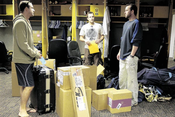 Tampa Bay Rays players, from left, Rocco Baldelli, Andy Sonnanstine and Dan Wheeler say their goodbyes after packing their belongings in the clubhouse Thursday afternoon Oct. 30, 2008 in St. Petersburg, Fla. The Philadelphia Phillies defeated the Rays to win the World Series.