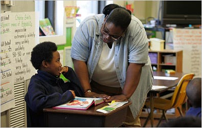 Former Principal MiShawna Moore working with a student in April at Sanders-Clyde Elementary School in Charleston, S.C. She is now working elsewhere, and the school is under investigation.
