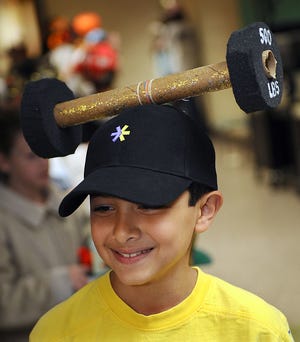 Defining the word "headstrong," Troy Fruneaux participates in a vocabulary hat parade at the Neary School in Southborough Friday.