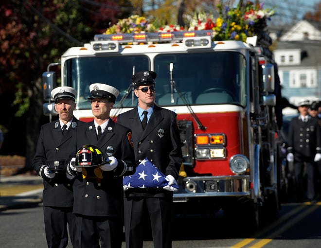 Capt. Douglas Stone, left, Capt. William Miles, center, and firefighter Michael Desjardins, all of the Sudbury Fire Department, lead a procession to St. Stephen's Church in Framingham Friday for the funeral of Sudbury firefighter J. Patrick Hanley. Hanley, 55, served as a firefighter and emergency medical technician for 30 years in Sudbury and Framingham. He died of cancer earlier this week.