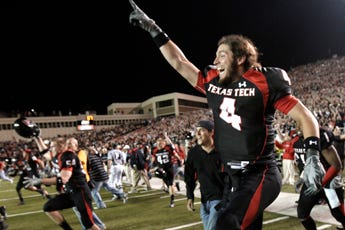 Texas Tech wide receiver Todd Walker runs onto the field with teammates after Texas Tech beat No. 1 Texas 39-33 on Saturday night.