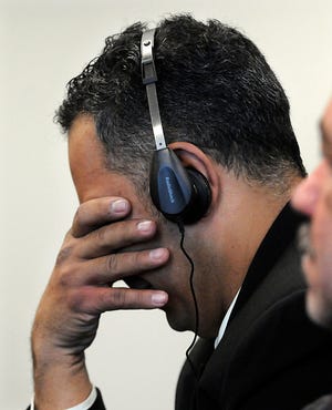 Elvio Maia of Milford covers his eyes while listening to 911 call his sister Carla Souza made just before she was murdered. Jeremias Bins is on trial for the killing.