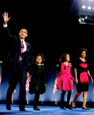 President-elect Barack Obama, left, his wife Michelle Obama, right, and two daughters, Malia, 7, and Sasha, 10, walk on stage at the election night rally in Chicago, Tuesday, Nov. 4, 2008. (AP Photo/Jae C. Hong)