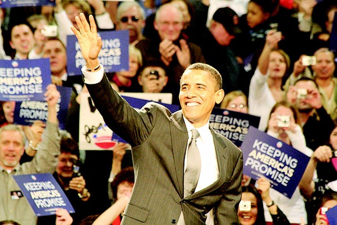Barack Obama waves to the crowd after a large win yesterday.