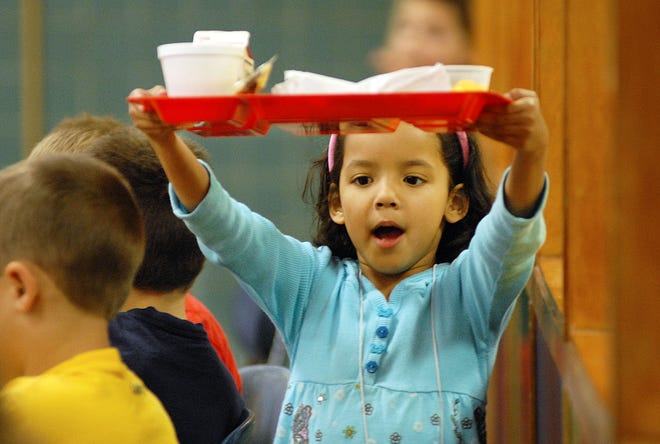 Kindergartener Lily Burnett, 5, carries her tray through the cafeteria during lunch at of New York Mills Elementary School Tuesday, October 28, 2008 in New York Mills.