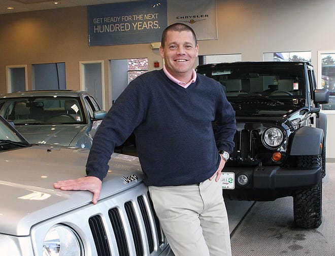 Michael Rowe, general manager of Brigham-Gill Motorcars, stands in the Natick showroom.