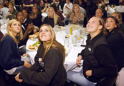 Clockwise from front-center, Missouri soccer players Krista Kruse, Kelsey Stokes, Kendra Collins, Kelsey Blincow, Liz Gayer, Jessie Crabtree, Candace Ruff, Mallory Stipetich and Kari Adam watch the NCAA Tournament selection show at D. Rowe's.