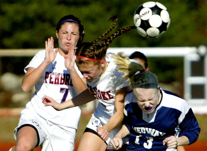 Pembroke's Mary Vercollone, left, and Jackie Squatrito, center, battle Medway's Sarah Coakley for a loose ball in the first half of Pembroke's 2-1 win Sunday in the first round of the South Division 2 tournament