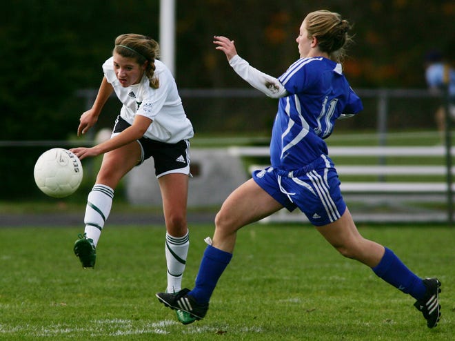 Jess Williams of Duxbury (left) tries to get the ball by Emily Fougere of Scituate.