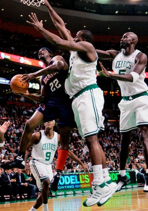 Atlanta Hawks' Ronald Murray (22) goes up to shoot against Boston Celtics' Kendrick Perkins, center, as Kevin Garnett, right, defends in the second quarter of an NBA basketball game, Wednesday, Nov. 12, 2008, in Boston.