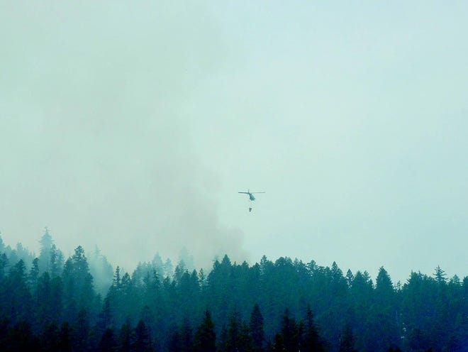 A helicopter drops water on a wildfire on Slinkard Peak, approximately three miles east of Seiad Valley along Highway 96, in mid-August. Hundreds of wildfires kept Siskiyou County firefighters busy this summer.