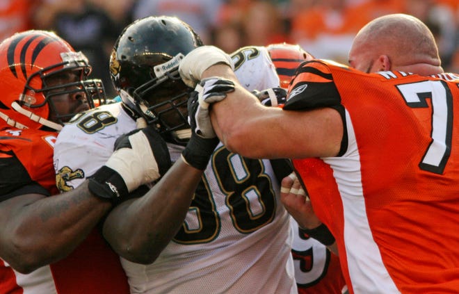 TONY TRIBBLE/Associated PressJaguars defensive tackle John Henderson (center) blocks a punch from Bengals tackle Andrew Whitworth (right) as they fight during the second half of a Nov. 2 game in Cincinnati. Bengals guard Bobbie Williams (left) holds back Henderson.