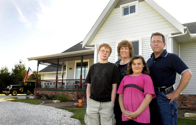 The Schmillen family, from left, Adam, 13; Regina; Lauren, 9; and Ken stand outside their Metamora home. Matt Dayhoff/GateHouse News Service