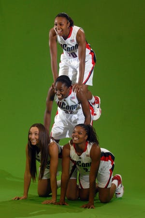 Top to bottom; Renee Montgomery, Kalana Greene, Cassie Kerns, left and Tahirah Williams make a pyramid for during a taping on media day at Harry A. Gampel Pavilion in Storrs.