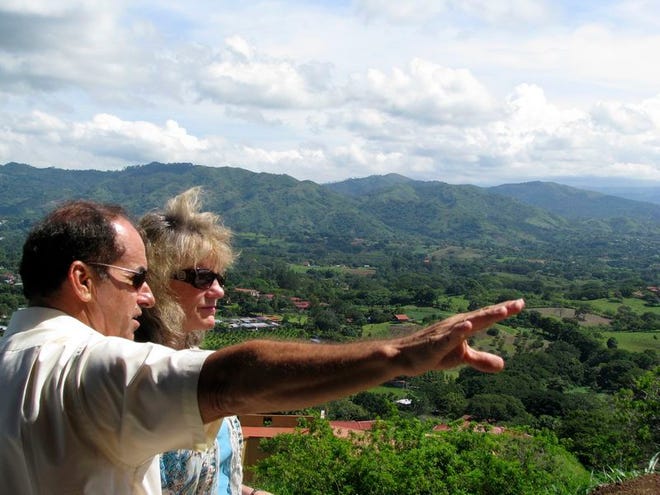 Rudy Matthews of Costa Rica Retirement Vacation Properties shows an Atenas hillside home site to Lanna Mingo, a Colorado woman who is considering making the move to Costa Rica.