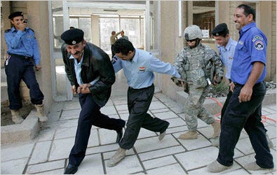 Iraqi policemen danced with a United States Army soldier in Baghdad on Sunday, the day Iraq’s cabinet approved a security pact.