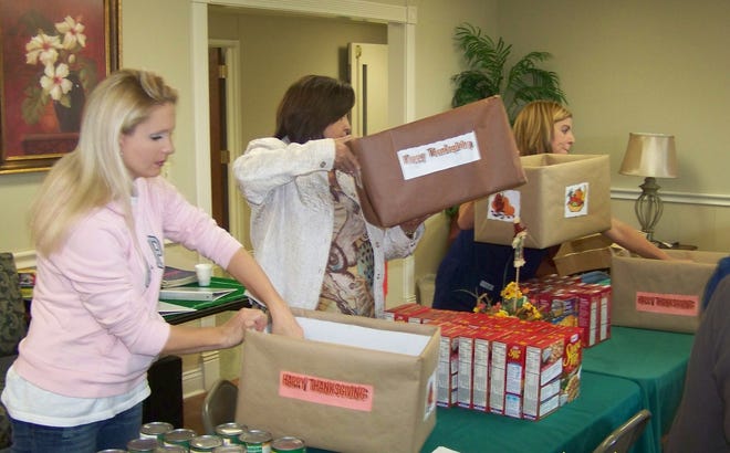 Committee members are pictured gathering food items to fill boxes for Seniors of Ascension Parish.