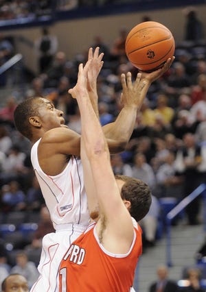 Connecticut's Kemba Walker drives past Hartford's Kevin Estes during the first half of their NCAA college men's basketball game in Hartford, Conn., on Monday, Nov. 17, 2008. (AP Photo/Fred Beckham)