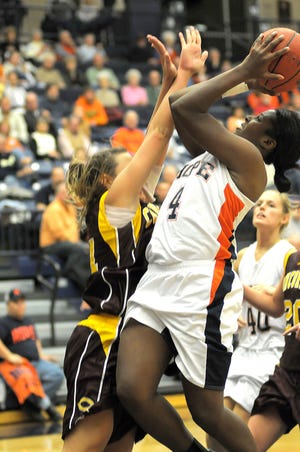 Hope's Philiana Greene (4) puts up a shot while Concordia's Jenna Freudenberg (10) tries to block her Friday night.