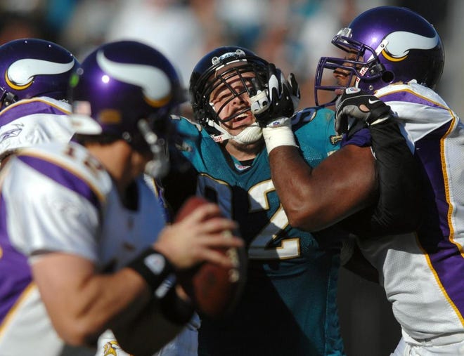 RICK WILSON/The Times-Union
Jaguars defensive tackle Rob Meier (center) takes a hand to his face while being blocked by Vikings offensive guard Artis Hicks on a third-quarter pass play during the Jags' 30-12 loss on Sunday.