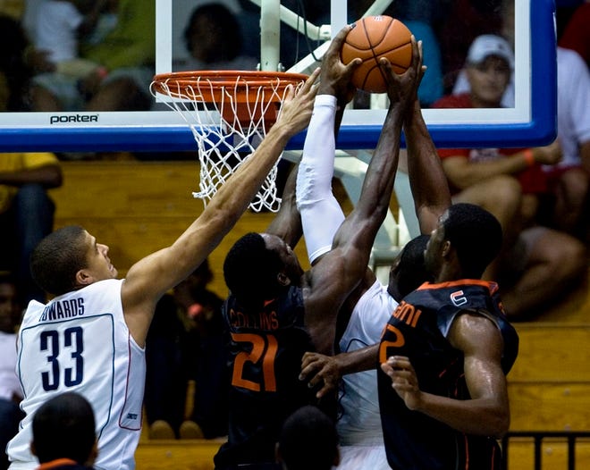 Connecticut's Gavin Edwards, left, and Jeff Adrien, second right, fight for 
a rebound against Miami's Dwayne Collins (21) and Brian Asbury during a game 
in the Paradise Jam in Charlotte Amalie, St. Thomas, U.S. Virgin Islands, 
Sunday.