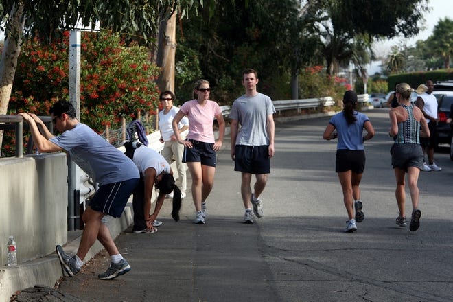NEW YORK TIMES PHOTOS / MONICA ALMEIDA
People stretch, walk, jog and run near 4th Street and Adelaide Drive in 
Santa Monica, Calif., last week. Park rangers, dispatched by police 
responding to residents complaining about noise and litter, have issued 
citations to some of the people exercising in the area.
