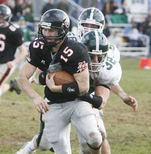Stoughton's Dan Snyder is tackled by Canton's A.J. Nichols and Chris Lane.