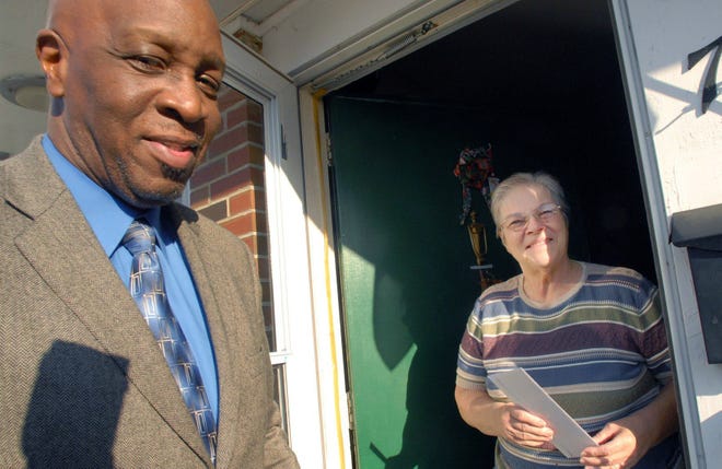 Norwich Rotarian Antonio Gooding, left, gives a $25 food gift card to Jackie Chalifoux, a resident of Harry Schwartz Manor, Wednesday, Nov. 26 in Norwich. Liberty Bank and the Norwich Rotary gave away 73 gift cards — one to each Harry Schwartz Manor resident and each Eastwood Court resident — to help with the holidays.