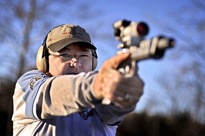 Helen Jeavons aims her Tanfoglio 9mm at the Green Valley Rifle and Pistol Club in Hallsville. Jeavons won the Ladies Division at the NRA World Action Pistol Championships.