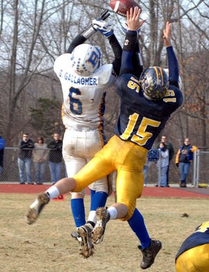 Up for grabs. Bacon Academy's Gallagher and # 35 battle RHAM's # 15 for this pass from RHAM QB John Rivosa. Darnell Isaacs / for the Norwich Bulletin.